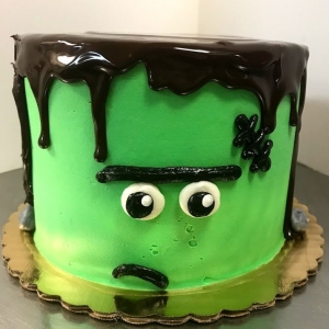 SPOOKY CUTE CARTOON GREEN FRANKENSTEIN MONSTER FACE HALLOWEEN COSTUME HOLIDAY BIRTHDAY CAKE WITH CHOCOLATE GANACHE IN CHICAGO ILLINOIS