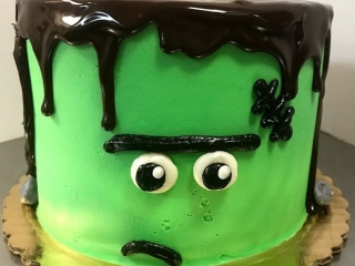 SPOOKY CUTE CARTOON GREEN FRANKENSTEIN MONSTER FACE HALLOWEEN COSTUME HOLIDAY BIRTHDAY CAKE WITH CHOCOLATE GANACHE IN CHICAGO ILLINOIS