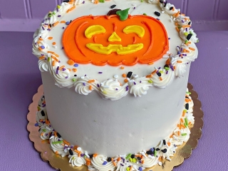 SMILEY CUTE JACK O LANTERN PUMPKIN FACE WITH SPRINKLES HALLOWEEN HOLIDAY FALL BIRTHDAY CAKE IN CHICAGO ILLINOIS
