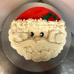 WHITE BEARD ROSETTE TEXTURE COVERED SANTA CARTOON HAT AND FACE WINTER HOLIDAY CHRISTMAS CAKE IN CHICAGO ILLINOIS
